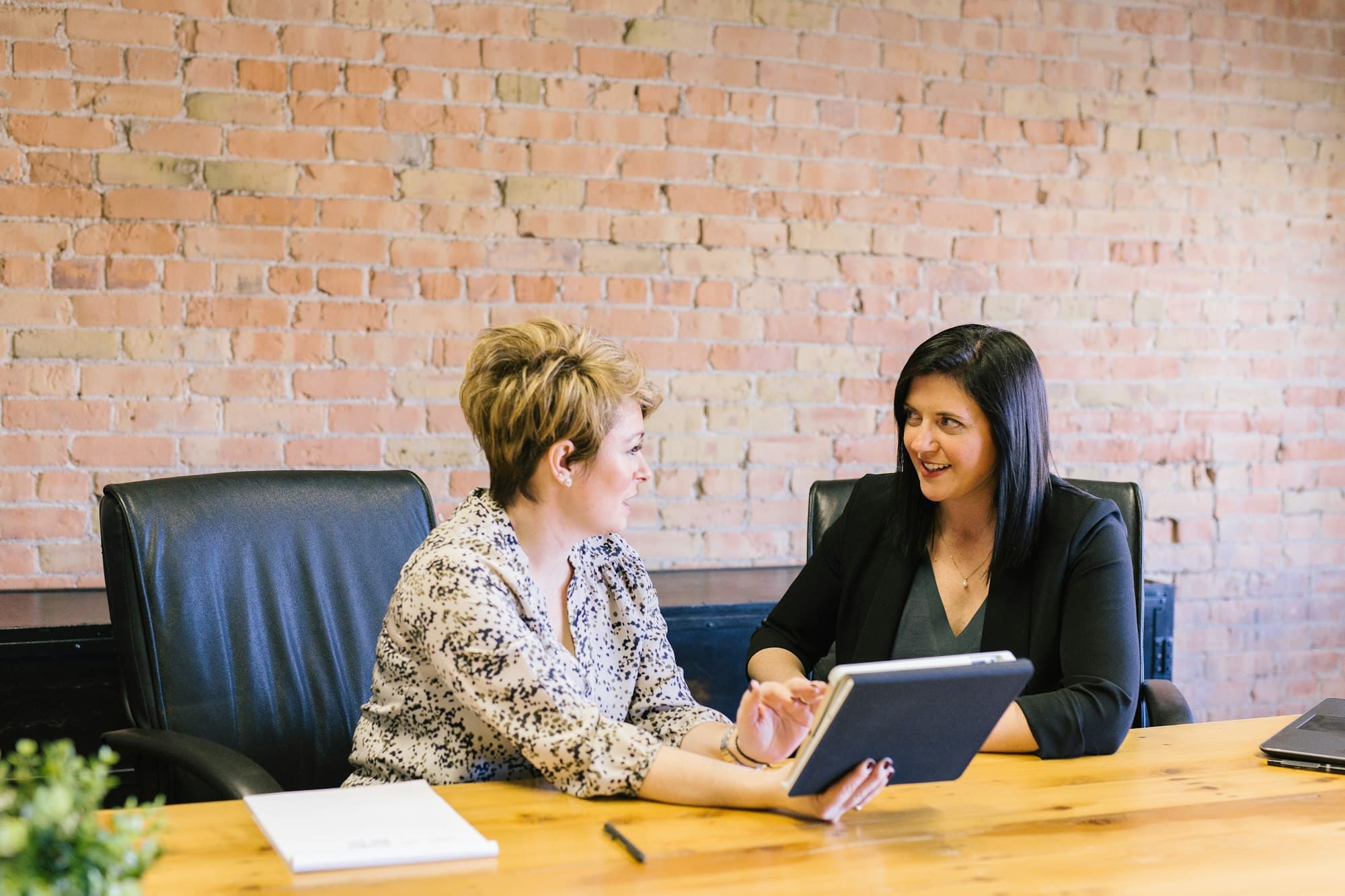 Two people in a meeting in a bright office